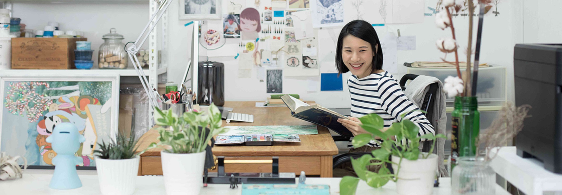 tan xi zi at her studio surrounded by plants and art