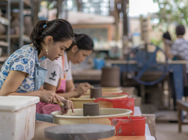 ladies engrossed in pottery 