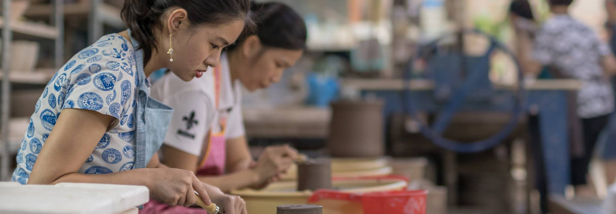 ladies engrossed in pottery 