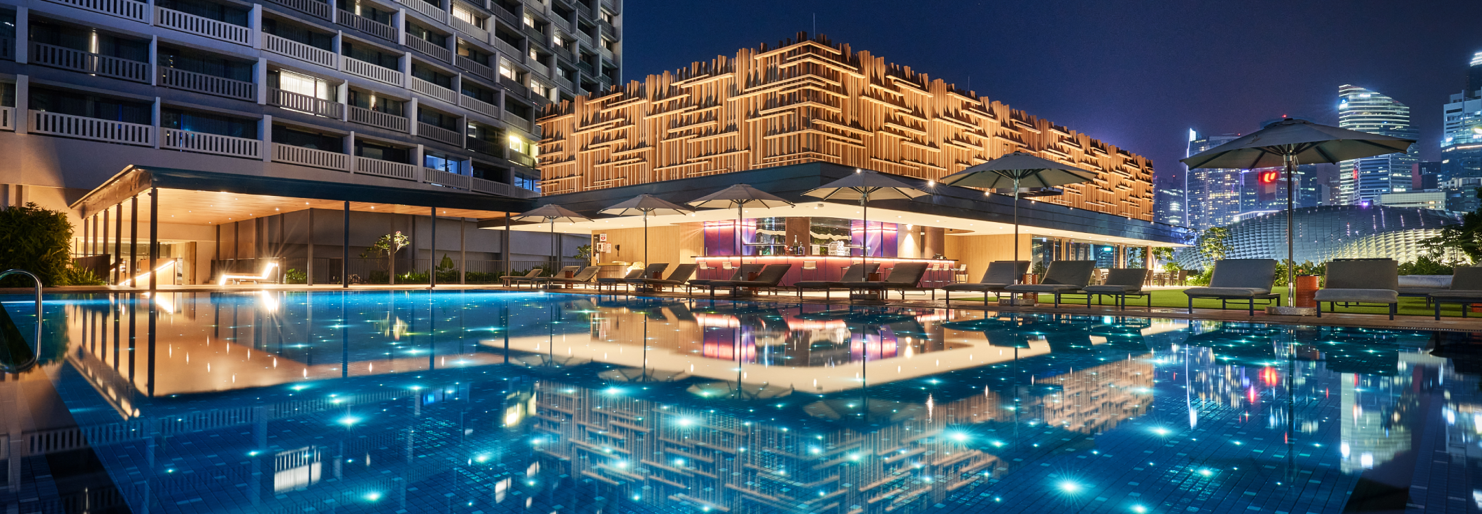 swimming pool at night with 1380 stars and outdoor skyline bar