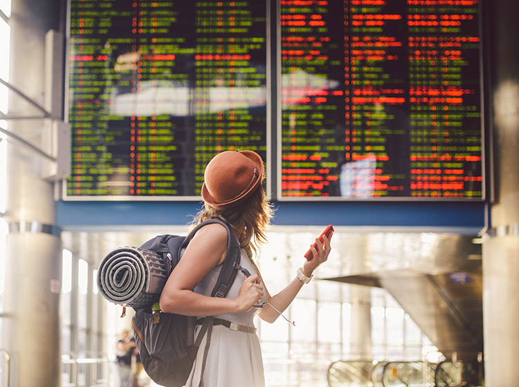 Solo traveller looking at the train schedule