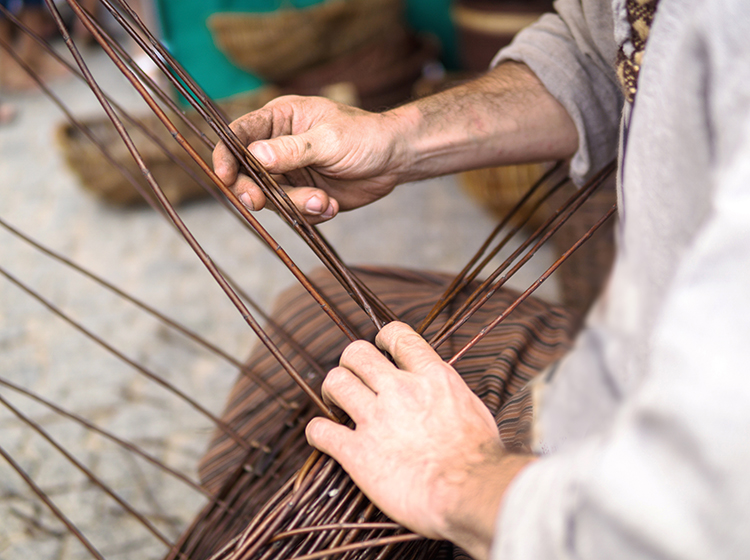 Close up of man doing basket weaving