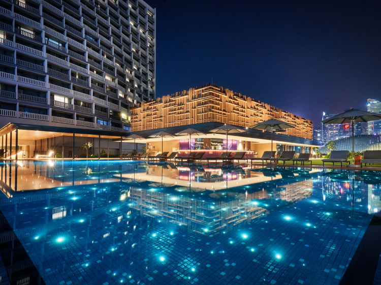 swimming pool at night with 1380 stars and outdoor skyline bar